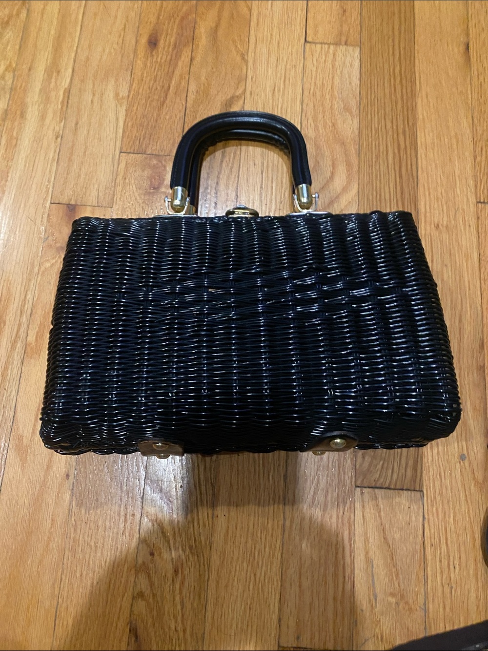 Elegant Black Woven Top-Handle Bag with Gold Accents